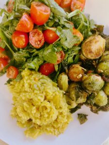 arugula-salad-lemon-juice-olive-oil-sweet-brussel-sprouts-raisings-garlicky-yellow-rice